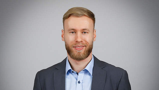 Portrait photo of a young man in a suit.
