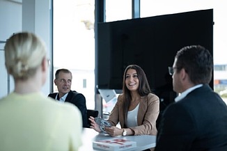 Your entry A team in a meeting room during a meeting.