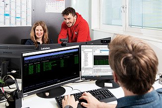 Software development colleagues work on software development processes and the in-house developed ERP system.